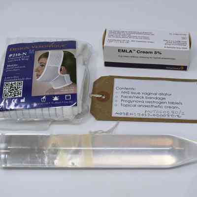 The image shows medical items including a bandage, cream, dilator, and an information tag detailing.