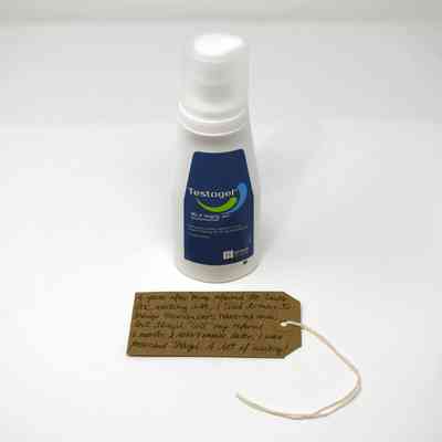 A bottle labeled "Testogel" stands beside a handwritten note on a tag.