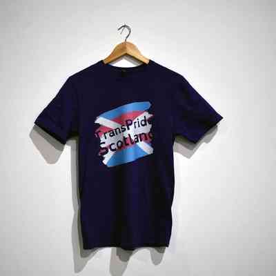 A t-shirt which is a navy blue and has a UK flag on the front which says 'Trans Pride Scotland'.