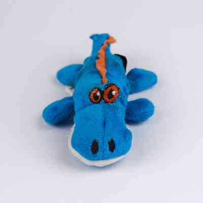 Blue, orange, and white crocodile-shaped dog toy. The eyes and spine of the toy have been visibly repaired with various threads.
