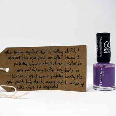 A bottle of Rimmel 60 second shine nail polish (colour: Lovey Dovey), with a brown handwritten luggage tag.