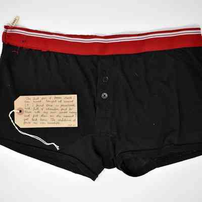 Black boxers with a red waistband with white stripe.