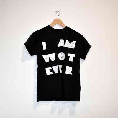 A black T-shirt with bold white text saying "I AM WOT EVER".