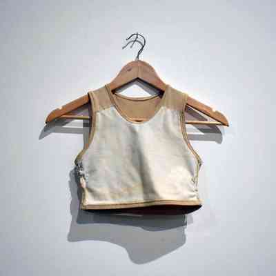 A beige binder on a wooden clothes hanger.