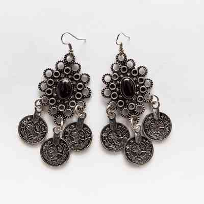 One pair of earrrings in drop style with hook, metal filigree, each with central black bead and three small discs hanging.