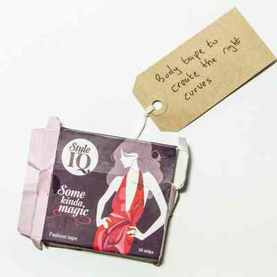 Black box showing white figure wearing pink dress. Box reads "Style IQ" and has some rips.