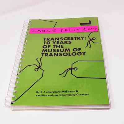 The image shows a spiral-bound book titled "Transcestry: 10 Years of the Museum of Transology".