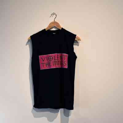 A black sleeveless T-shirt with "VIOLENT THEMMES" in pink text.