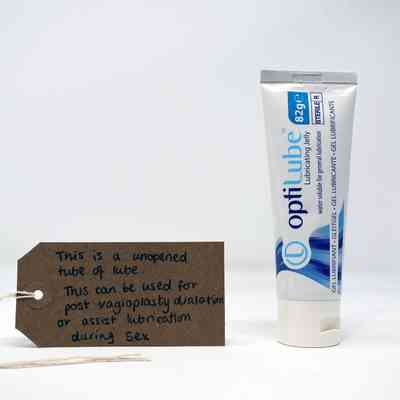 White tube with blue lettering reading "optiLube Lubricating Jelly"