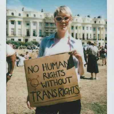 A person holds a sign which says "No Human Rights Without Trans Rights".