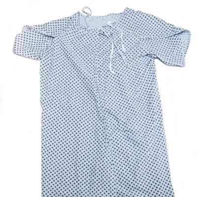 The image shows a light blue hospital gown with a diamond pattern and ties at the back.