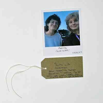 A Polaroid photo shows two people smiling, dated 25/06/23.