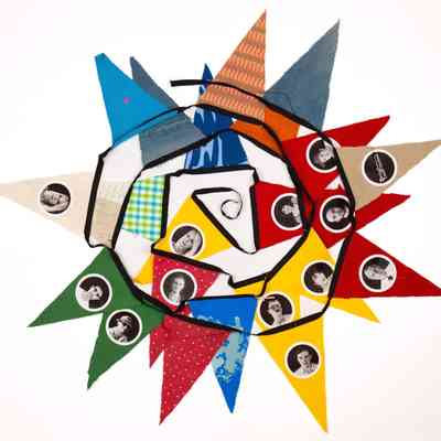 Bunting which is displayed so it is sat flat and in a spiral, overlapping. The bunting is a mixture of colours such as yellow, gree, red, blue and patterened fabric pendants. Some of the pendants have photographs of people on them.