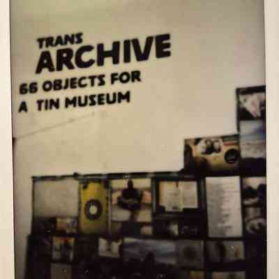 The image shows a wall display titled "TRANS ARCHIVE".