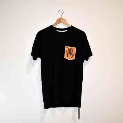 Black t-shirt with they them print on breast pocket.