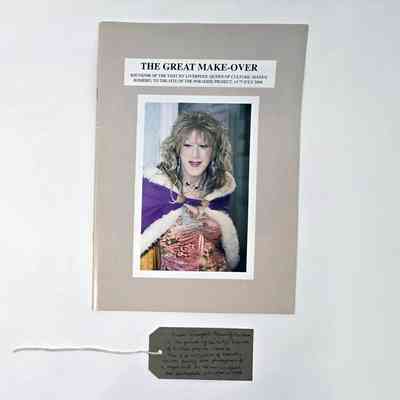 A booklet titled "The Great Make-over" features a person in colorful, elegant attire. With a brown, handwritten luggage tag.