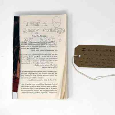 A book with the front page cut off with handwritten text on the pages.