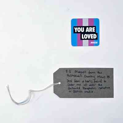 The image shows a "You Are Loved" magnet from Minus18 beside a handwritten note.