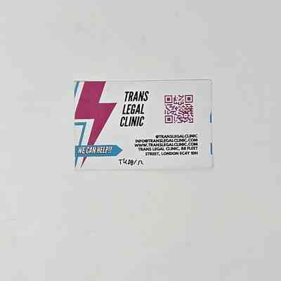 A white business card for the Trans Legal Clinic. There is a pink and blue lightning logo and a pink QR code, with contact details in black text.