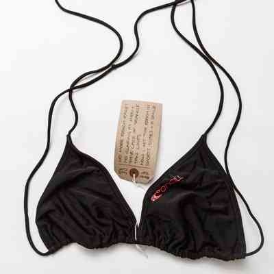 The image shows a black bikini top with string ties and an O'Neill brand logo on the left cup.
