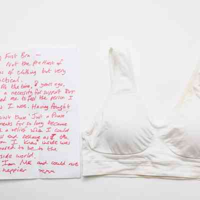 White sports bra with a letter on the left with writing in red pen.