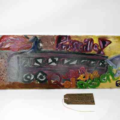 A colourful paining which says 'Priscilla Queen of the Desert'
