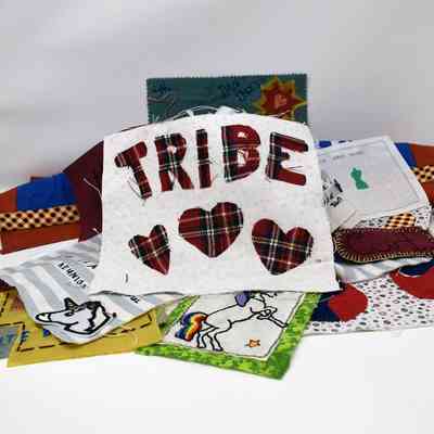 The image features diverse fabric patches with designs, including "TRIBE" and hearts.