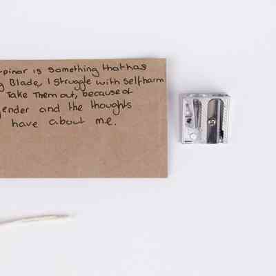 Metal double pencil sharpener & 1 tag; blade of larger aperture has been removed.