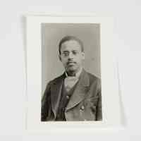          The image displays a formal portrait of Lewis Latimer in a suit, reflecting a historical setting.
   