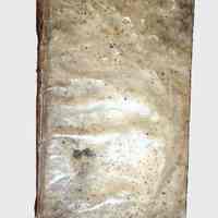          The Six First Books of Euclid; The image shows an old, weathered book with a discolored and stained cover, giving it a vintage appearance; the surface is marked with various spots and creases, hinting at its age and the exposure to environmental conditions over time.
   