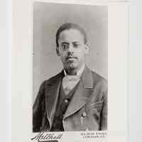          Survey #31 - DSC_7238; A sepia-toned portrait depicts Lewis Latimer in a suit with glasses, against a plain studio background
   
