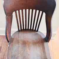 A wooden swivel office chair