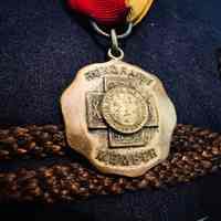          Honorary Member; A close-up of a gold medal labeled 