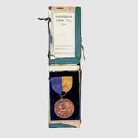          District Award medal; A District Award medal from the New York Music Week Association (1927–1928), awarded for piano excellence, housed in its original Sherman Manufacturing Co. presentation box.
   