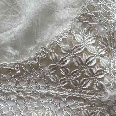 Detail Maltese lace on the corner of the handkerchief