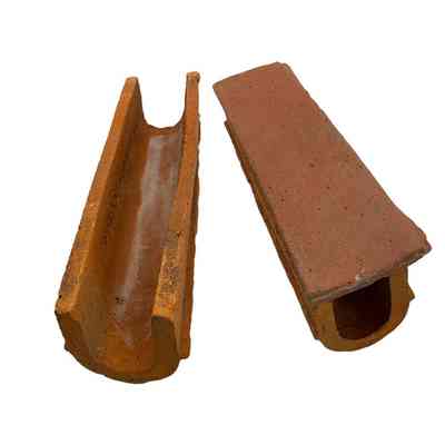 Horseshoe clay drainage pipe, showing open and with flange cover