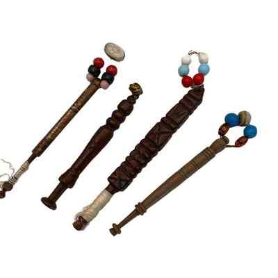 Four wooden bobbins with glass beads