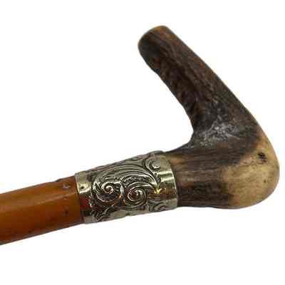 Detail handle of children's crop, showing horn handle and silver hasp