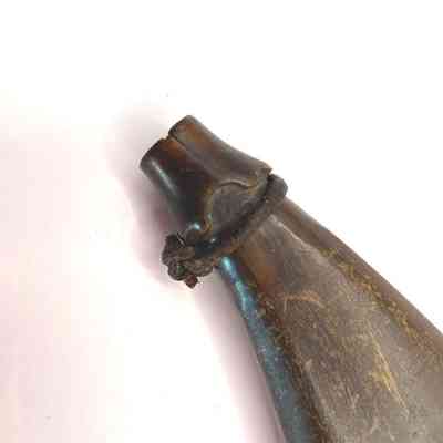 Detail of leather tie around the neck of the powder flask