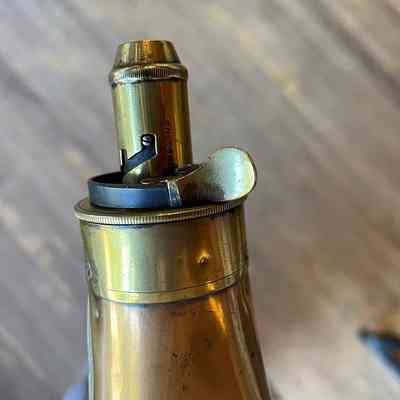 Detail of the brass fitting at the top of the copper powder flask.