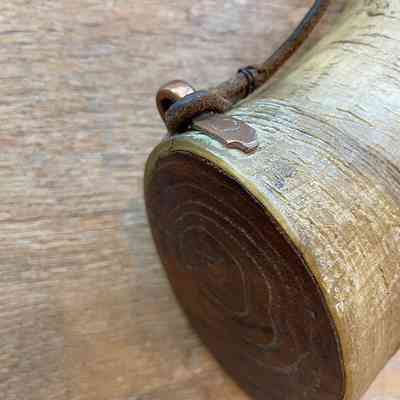 Horn powder flask detail showing brass fitting to hold leather thong