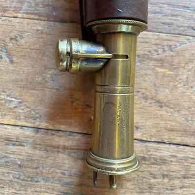 Detail of brass closure fitting with the Dixon & Sons engraving and the protruding post to open the carrier and pullout the scoop.