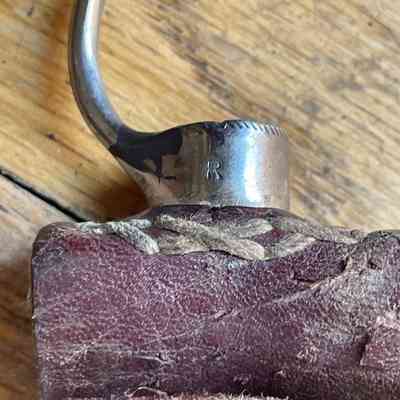 Detail of join of metal and leather in a cockfighting spur