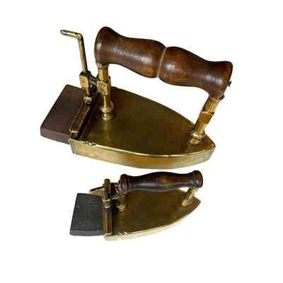 Large and small brass hair irons showing heating stones