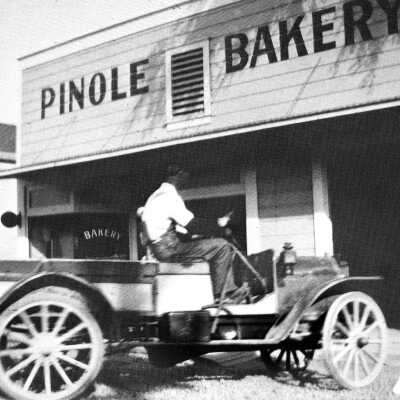Pinole (Woy) Bakery (city): The Pinole Bakery was sold to the T.W. Woys by J.B. Downer, brother of E.M. Downer Sr. Newcomers here from Pennsylvania, the Woys expanded into the grocery business in 1906 and had the first auto delivery. Their home (left) is on the southwest corner of San Pablo and Valley avenues, next to the store. The house still stands. The bakery was the Top Cafe in the 1960s and is a State Farm insurance agency today.