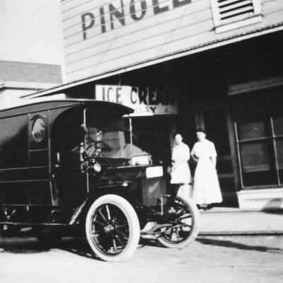 Pinole Bakery (7844T) CCCHS: An early 1900s delivery truck parks outside the Pinole Bakery. The Woy family home (left) is on the southwest corner of San Pablo and Valley avenues, next to the store. The house still stands. 