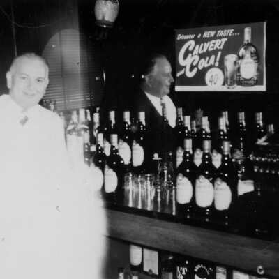 Tommy Prather inside Tommy's 1960 #2 (Margaret Prather): Blurred photograph of Tommy Prather behind the bar counter at Tommy’s Cafe in 1960.