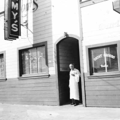 Tommy Prather outside Tommy's 1960 (Margaret Prather): Tommy Prather stands in front entrance of Tommy’s Cafe in 1960.