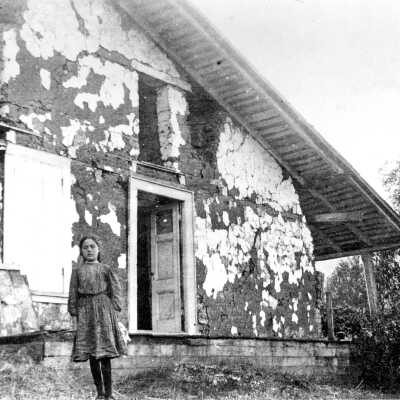 Ramona Martinez in front of adobe ruins, 1911