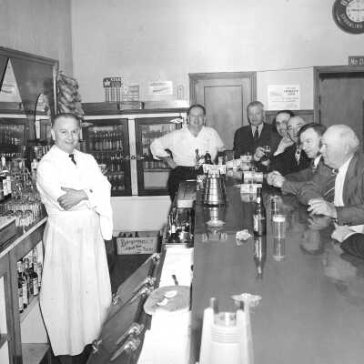 Tommy's-original #2 (Prather): In 1945-46 Tommy’s Cafe was known as Harry Skow’s bar. Gladys Skow, Harry’s daughter, and her husband, Tommy Prather (behind the counter), took over the business, and it was called Tommy’s Cafe. It was a gathering place for coffee, conversation, and local news and gossip. It was in the same building that housed the Manuel Marcos Saloon at the turn of the 20th century, and today houses the Bear Claw Bakery. 